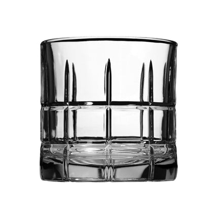 A clear cut-glass rocks tumbler with a thick base and vertical faceted detailing, shown on a solid white background.