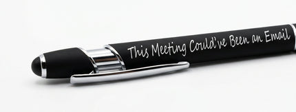 A black pen with white cursive text reading 'This Meeting Could've Been an Email.' resting on a textured black surface.