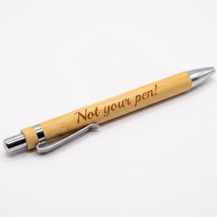 wooden pens engraved with the phrase 'Not your pen!' in black script, arranged diagonally on a plain white surface.