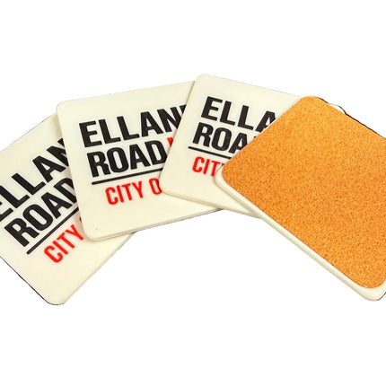 Four square coasters fanned out on a dark surface. Three coasters are white with black text reading 'ELLAM ROA.