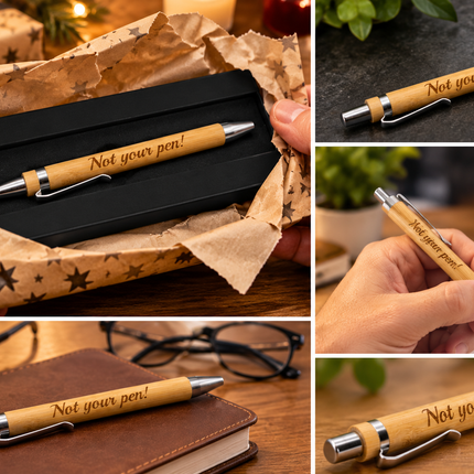 A collage showing a personalized wooden pen engraved with 'Not your pen!' in multiple lifestyle contexts: resting on a brown notebook, held in a hand, displayed in a black presentation box with brown star-patterned wrapping, and placed on a dark surface.