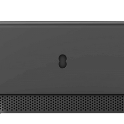 A dark gray rectangular electronic device with rounded corners, a small central keyhole-shaped cutout, and a perforated mesh grille along the bottom edge, shown against a black background.